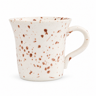 White ceramic coffee cup with brown speckles and a curved handle on a white background
