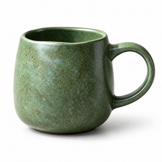 Green speckled ceramic coffee mug with loop handle on a white background
