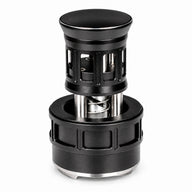 Black 58mm press-style rotating espresso distributor with adjustable depth and a stainless steel base.