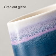 Close-up of the ceramic cup's ivory rim and speckled lavender-to-blue gradient glaze