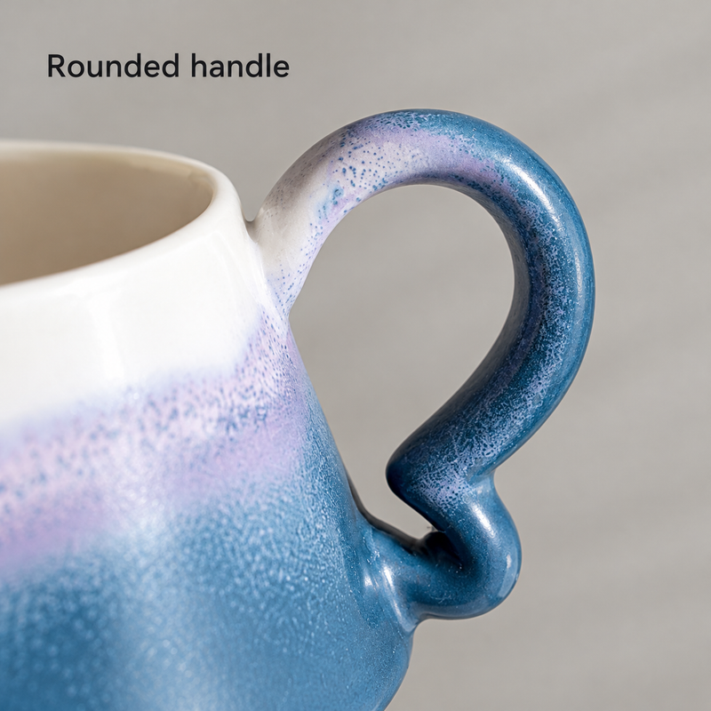 Close-up of the blue and lavender cup's rounded loop handle and curled lower attachment