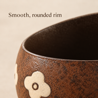 Primo piano del bordo arrotondato e dell'interno scuro della tazza in ceramica Fiori marroni