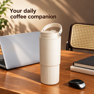 Latte Beige 800 ml tumbler with carry handle on a wooden desk beside a notebook and laptop.
