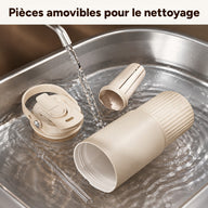 Gobelet beige, couvercle à poignée, infuseur à thé et paille transparente démontés pour le rinçage dans un évier