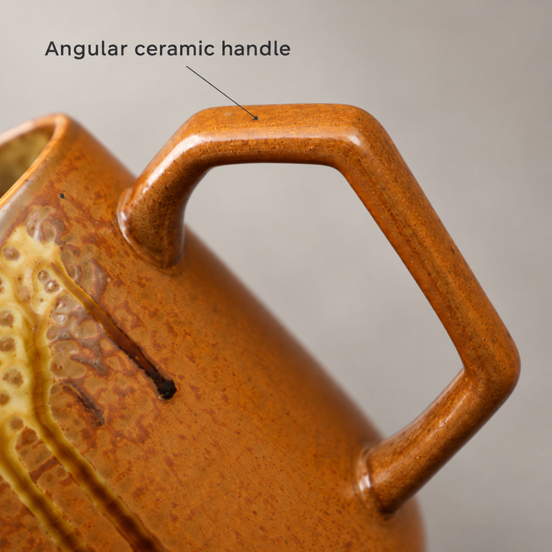 Close-up of the angular ceramic handle and amber glaze on the coffee server