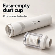 Removable 79 mL dust cup with pleated filter beside the white vacuum motor body