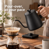 Black wooden-handle electric kettle pouring water into a glass pour-over dripper