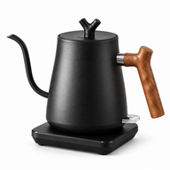 Black electric gooseneck kettle with wooden handle and mechanical switch on a black square base against a white background
