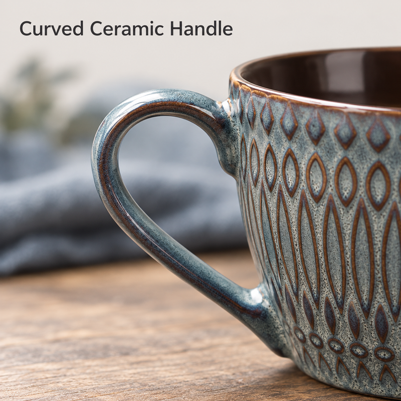 Close-up of the embossed ceramic coffee cup's curved loop handle