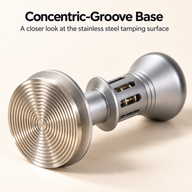 Silver espresso tamper showing its concentric-groove stainless steel tamping surface