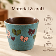 Turquoise bows ceramic coffee cup with hand-painted underglaze decoration and approximately 300 ml capacity