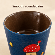 Close-up of the rounded rim and brown glazed interior of the ceramic coffee cup