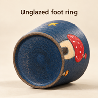 Underside of the navy mushroom ceramic cup showing the unglazed brown foot ring