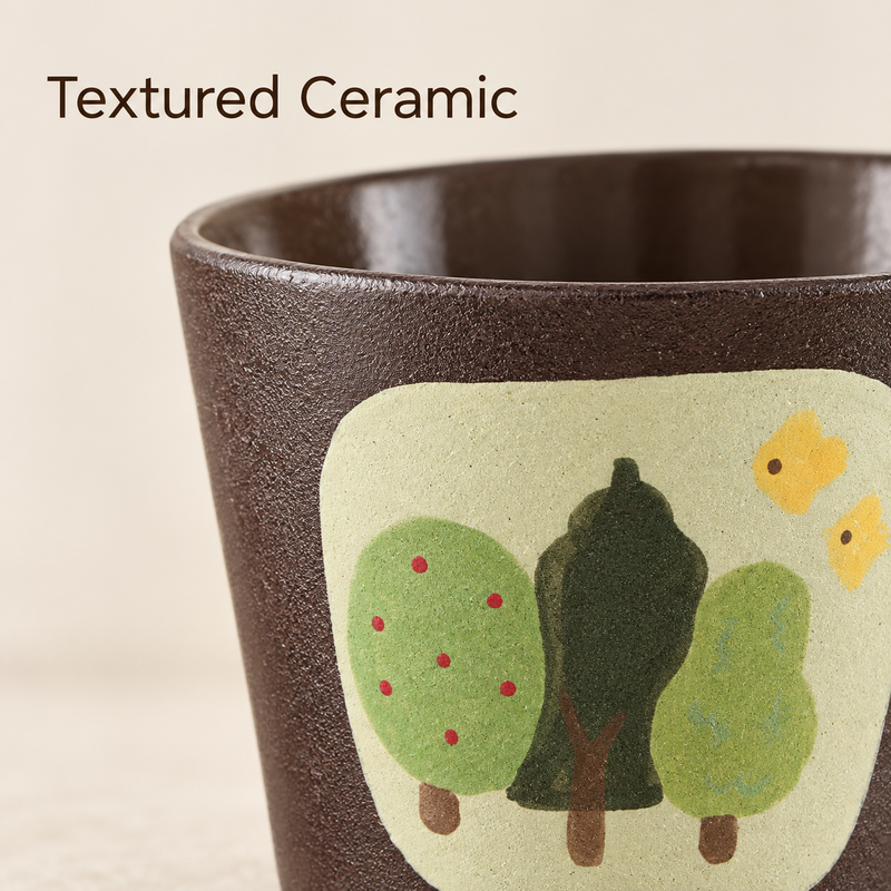 Close-up of the brown textured ceramic surface and green tree artwork