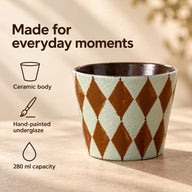 Diamond-pattern ceramic cup with callouts for ceramic body, hand-painted underglaze and 280 ml capacity.