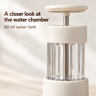 Close-up of the manual espresso maker's transparent ribbed 80 ml water tank and press plunger