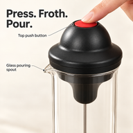 Close-up of the red top push button and glass pouring spout on the milk frother