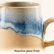 Close-up of the blue and white reactive glaze above the sand-colored ceramic body