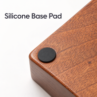 Close-up of a round black silicone pad on the underside corner of the sapele wood espresso station.