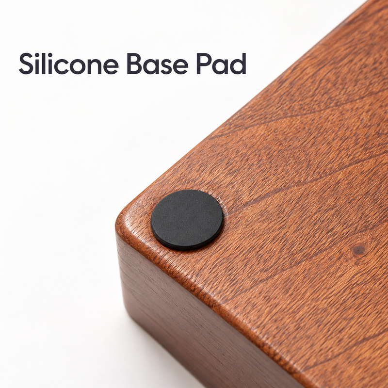 Close-up of a round black silicone pad on the underside corner of the sapele wood espresso station.