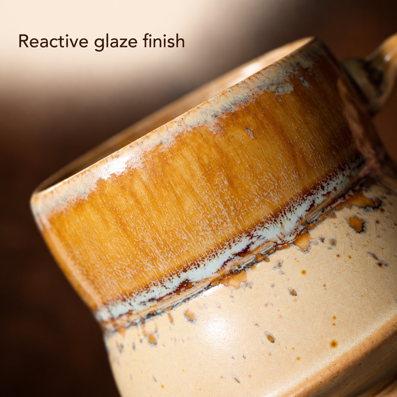 Close-up of the amber glaze and speckled ivory finish at the mug waist