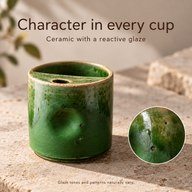 Small green ceramic cup on a stone surface with an inset showing its reactive-glaze texture.
