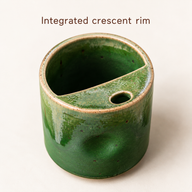 Top detail of the integrated ceramic crescent rim, oval sip opening and open rear aperture.
