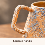 Close-up of the squared ceramic handle and mottled blue and ochre glaze