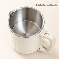 Close-up of the brushed 316 stainless steel interior, rim and pouring lip of the cream kettle.