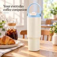 Ivory 750ml tumbler with pale-blue handle beside iced coffee on a breakfast table