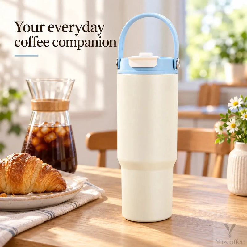 Ivory 750ml tumbler with pale-blue handle beside iced coffee on a breakfast table