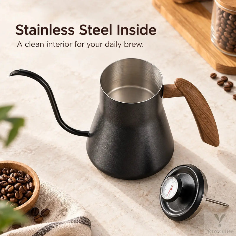 Open black kettle showing its stainless steel interior and removable thermometer lid