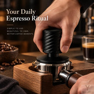 Hand pressing the black spring-loaded espresso tamper in a portafilter on a wooden tamping station
