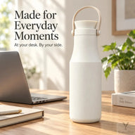 Ivory Yozcoffee insulated bottle on a sunlit desk beside a laptop