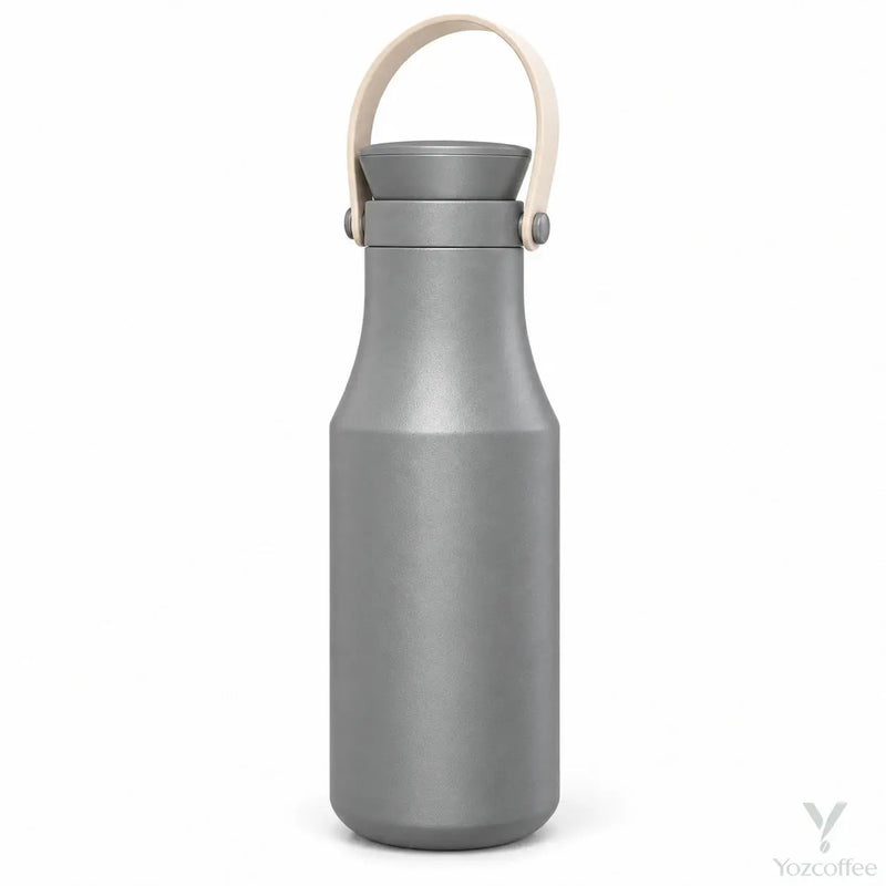 Gray Yozcoffee insulated stainless steel bottle with beige carry handle on white