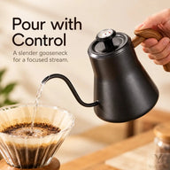 Curved gooseneck spout of the black kettle directing water into a pour-over filter