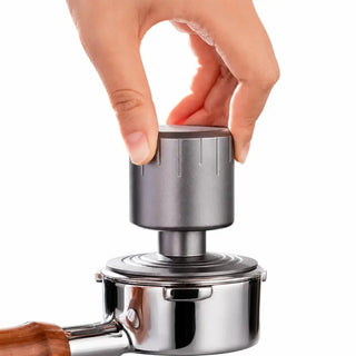 Close-up of the silver spring-loaded espresso tamper
