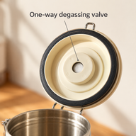 Close-up of the one-way degassing valve and black sealing ring beneath the white canister lid