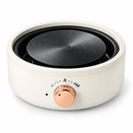 Plaque chauffante électrique Smooth Rim blanc ivoire avec disque chauffant en acier rainuré et bouton de commande or rose, sur fond blanc