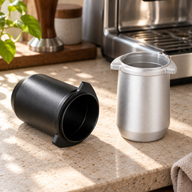Black and Silver 54 mm aluminum espresso dosing cups on a coffee countertop