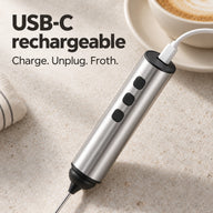 USB-C charging cable connected to the top port of the silver three-button milk frother