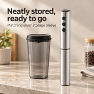 Silver three-button milk frother stored in its matching sleeve beside the full-set cup