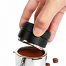 Hand using the Yozcoffee black 3-leaf espresso distributor over a portafilter filled with coffee grounds