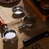 Yozcoffee 54mm bottomless portafilter parts and solid wood handle on a textured surface