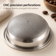 Close-up of the dense spiral perforations on the rounded underside of the espresso basket