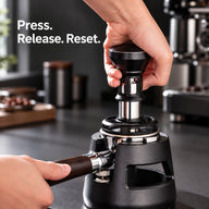 Hand pressing the 58mm impact tamper into an espresso basket