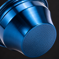 Close-up of the perforated base of the blue tapered espresso filter basket