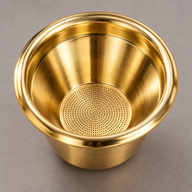 Gold tapered espresso filter basket interior with perforated circular base