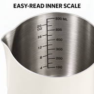 Brushed stainless steel interior of 600 ml milk pitcher with milliliter and ounce markings