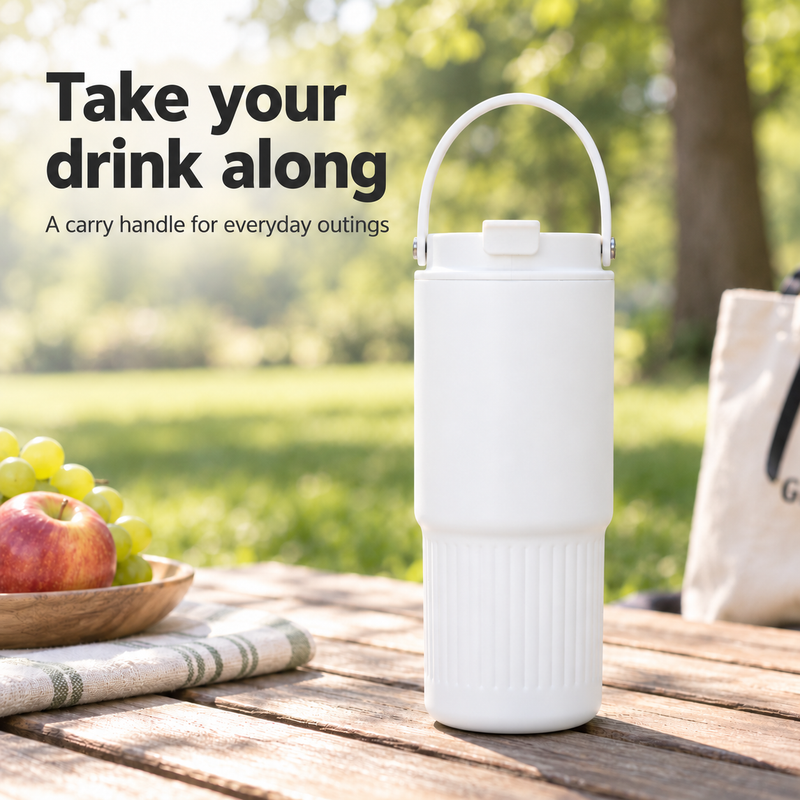 White 750ml insulated tumbler with carry handle on an outdoor picnic table